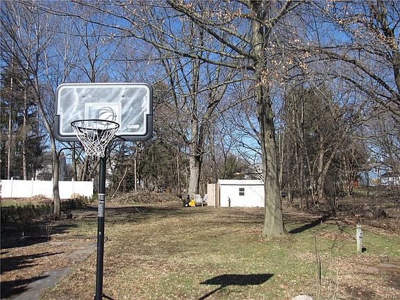 The back yard is over 200 feet deep!  The shed belongs with the home.