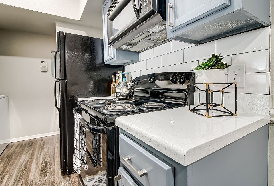 Model kitchen with gray cabinets and gas stove