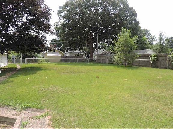 Fenced, double lot back yard.