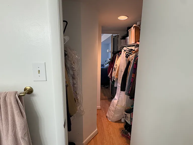 Second bathroom door that opens towards the spacious walk-in closet for primary bedroom.