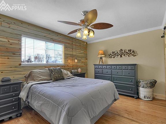 The master bedroom with a custom reclaimed wood shiplap wall!