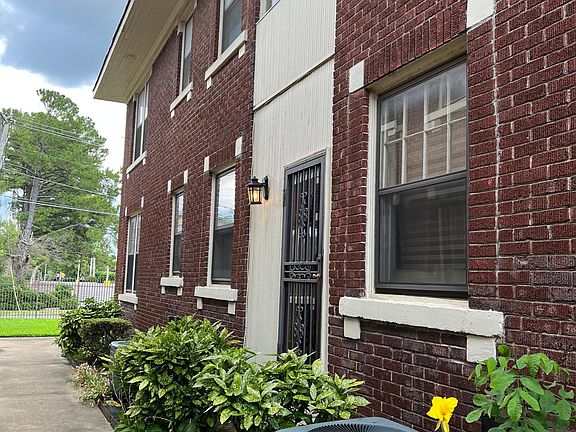 Walkway from back side parking lot to side entrance to hallway in building (that leads to kitchen entry door) and to front of building.