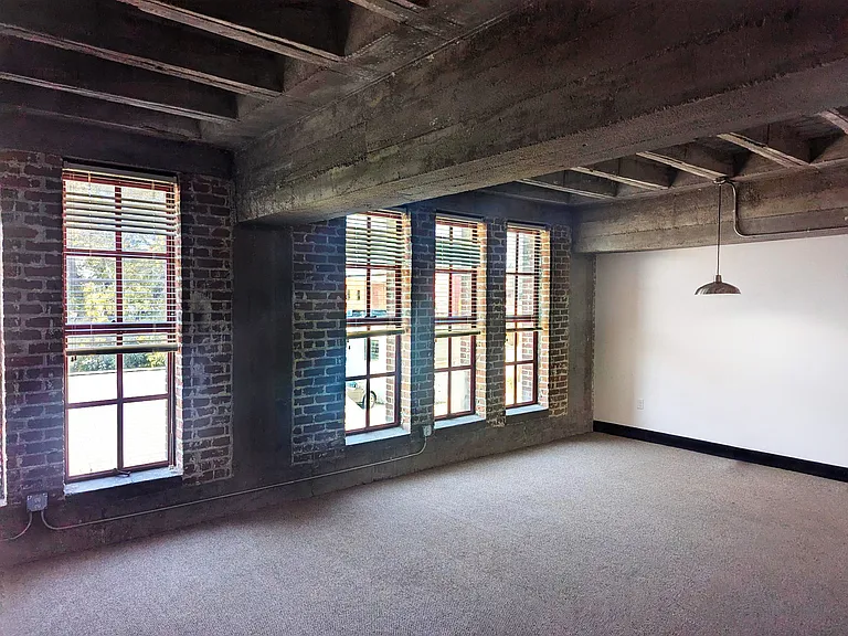 Brick wall and beams in a livingroom at 3 Points Loft.