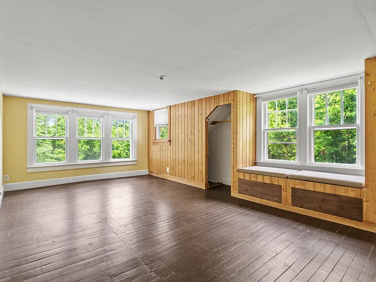 Bedroom 3 (primary - upstairs): Read a book in the window seat.