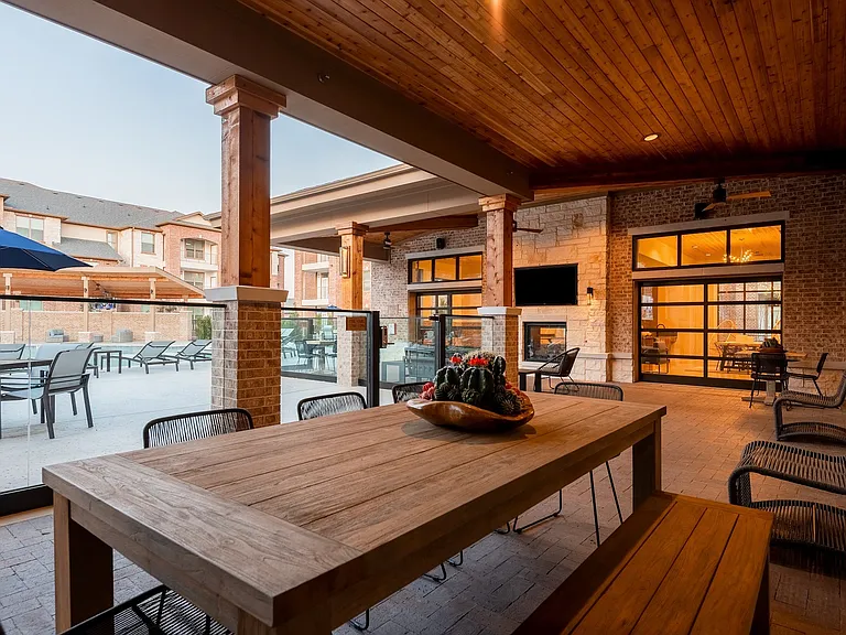 Indoor/outdoor seating area with televisions.