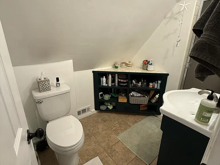 Second level bathroom with sink, toilet, and shower.