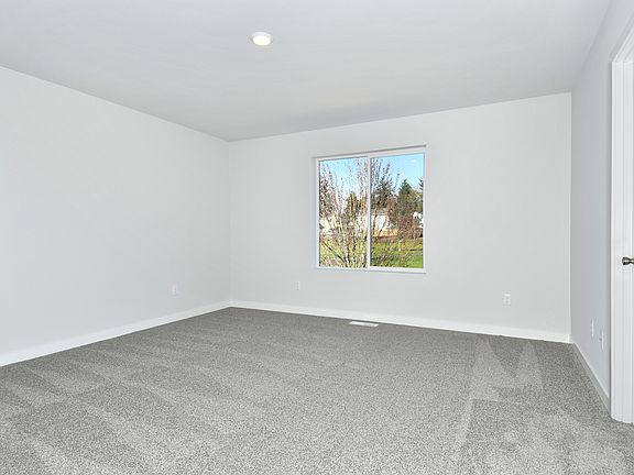 The master bedroom is spacious with a large window.