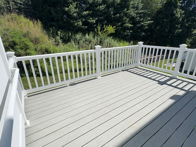 Spacious deck for outdoor dining and relaxing overlooking large yard in quiet neighborhood.