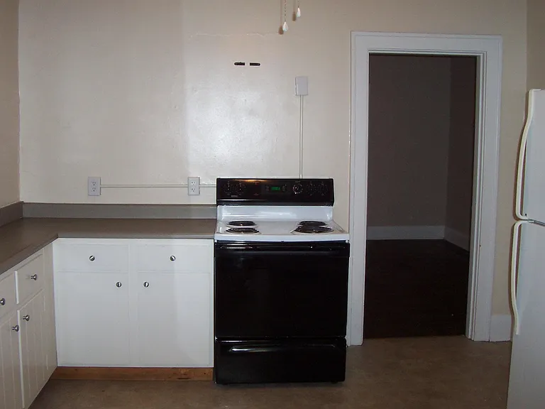 Kitchen with range, dishwasher and refrigerator