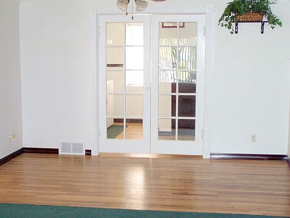 Dining Room with french doors and beautiful hardwood floors!