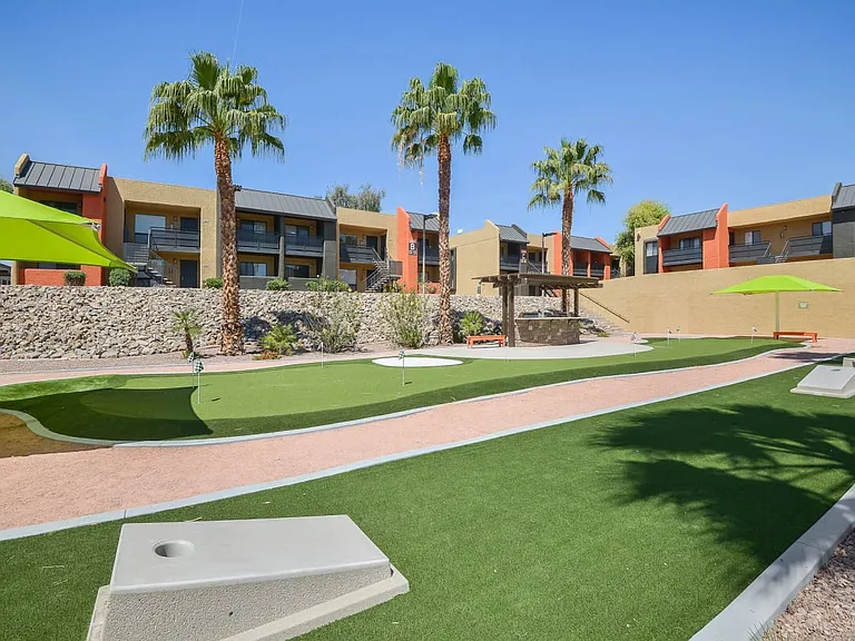 Courtyard with cornhole and putting green