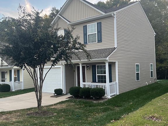 Exterior of House showing driveway and one car garage.