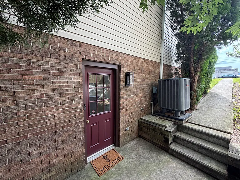 Side entrance with newly painted door and dusk to dawn light