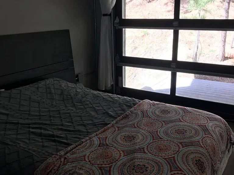 Studio set up with bed near the entrance