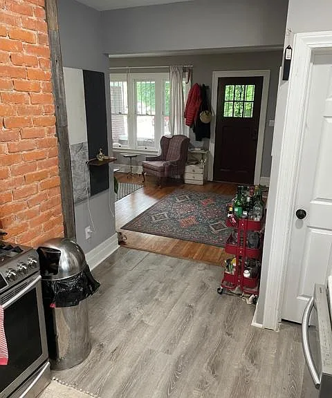 Standing in the kitchen facing to the front door. The first floor has been opened to provide on open concept.