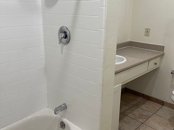 Full bath with tub and shower, large dressing table with same built ins