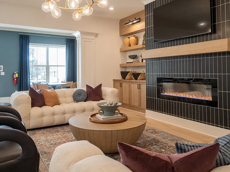 Clubhouse living room with ample seating, fireplace and TV.