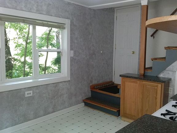 Kitchen, door to deck and stairs to second floor.