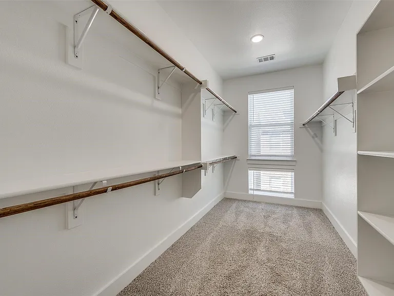 Primary Bedroom Walk-In Closet with lots of space.