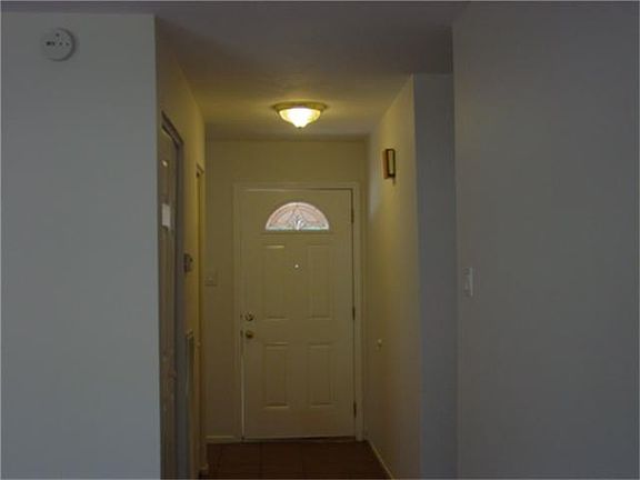 Entryway with tile flooring and two closets