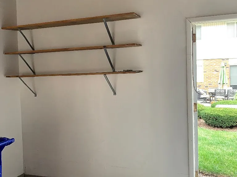 Newly drywalled Garage w/shelves and new baseboards