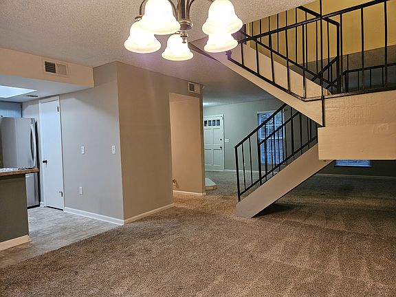 Dining area looking into kitchen and living area
