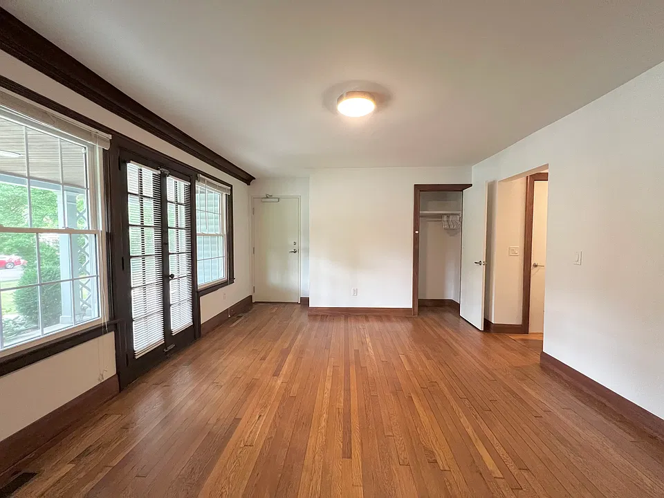 Spacious living room with hardwood floor and big windows
