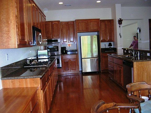 Huge galley style kitchen with granite counters and hardwood floors