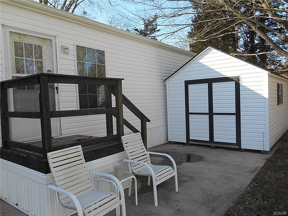 Side view of home with small deck and shed