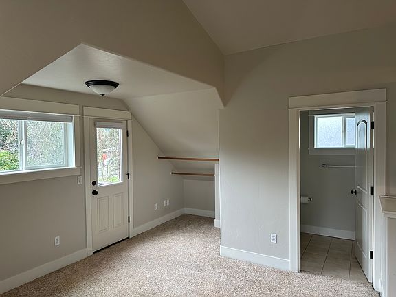 Room showing bathroom, closet, and door to balcony