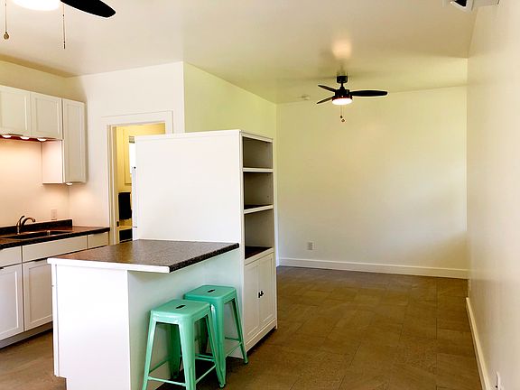 Kitchen with bar seating. Alcove bedroom is beyond.
