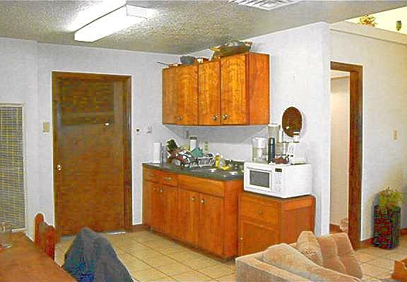 Kitchen has refrigerator and gas stove