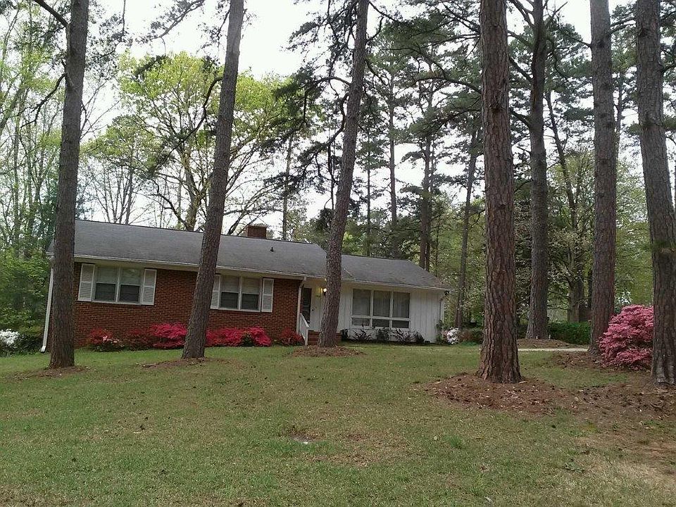 large yard, driveway with ample parking to the side