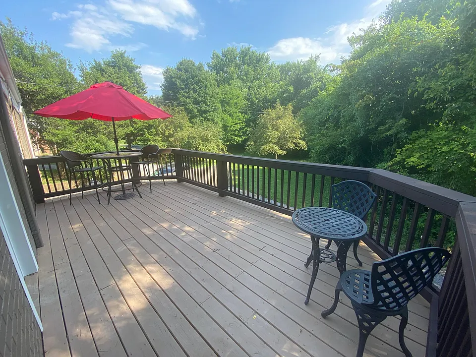 Grand Balcony overlooking private tree-lined back yard