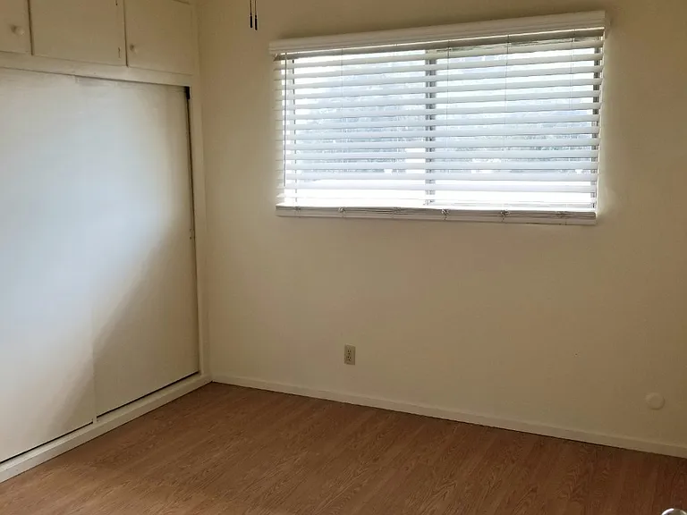 Bedroom #2- same size as bedroom #1 with a lot of closet space. Sliding closet doors with extra storage cabinets on top.