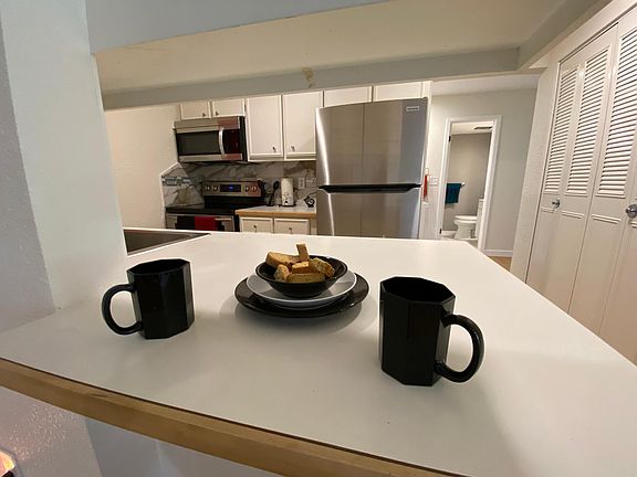 Kitchen with a BREAKFAST BAR and PANTRY