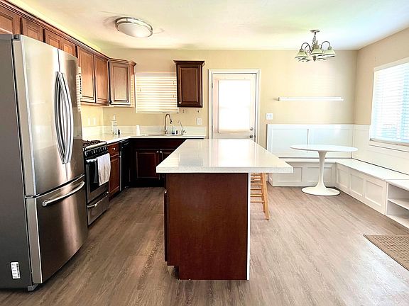 Kitchen with large island & extra seating, s/s appliances, custom built-in dining nook with more storage!