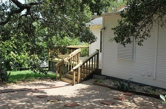 shady backyard with large deck
