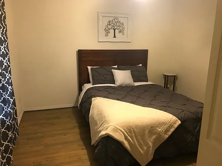 Queen bed with drawers for storage, dresser, closet and TV