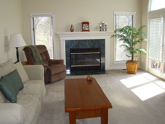 Great Room with Fireplace and Door to Private Deck