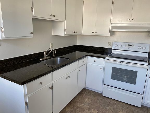 Kitchen granite counters with newly painted cabinets, new hardware, and new interior lined drawers.