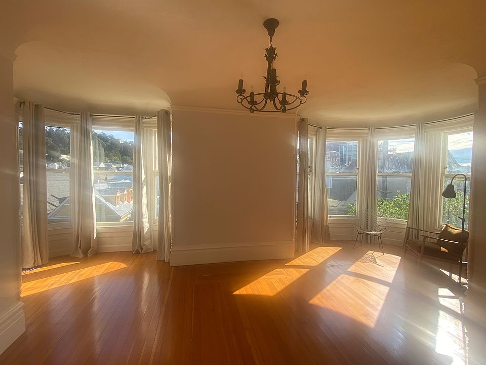 huge living room or bedroom (has closet) with two round bay window areas.