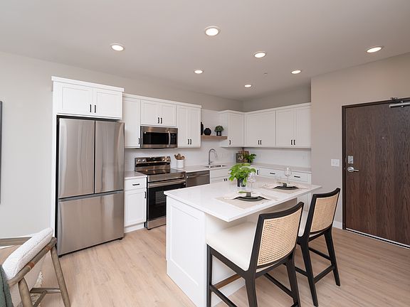 A functional kitchen island with seating that supports casual meals and gathering.