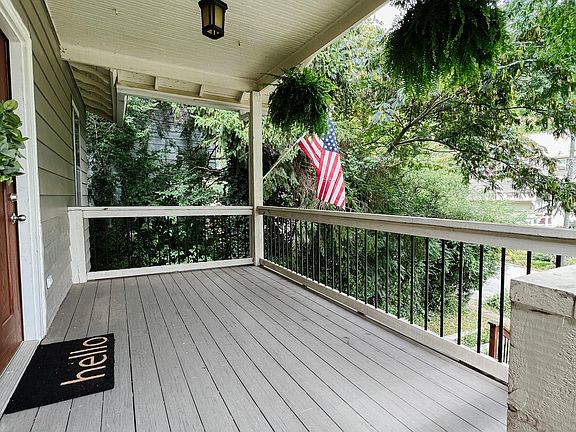 Beautiful covered front porch with North Shore views and hooks for a porch swing