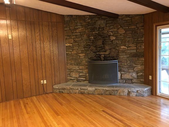 Living room with working rock fireplace.