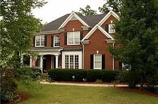 Gorgeous brick front home with rocking chair porch!