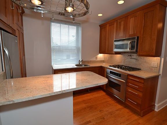 updated kitchen with custom cabinetry and stainless steel appliances