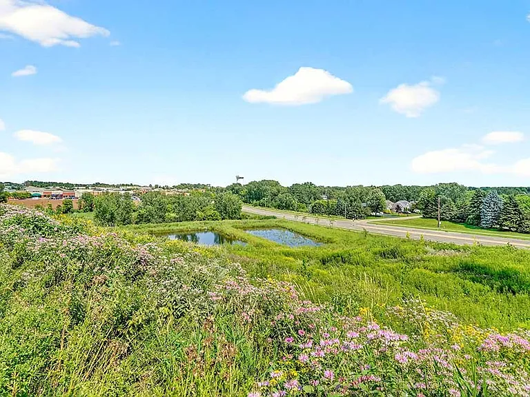 Modern residences set against open green space create a peaceful backdrop for everyday living.