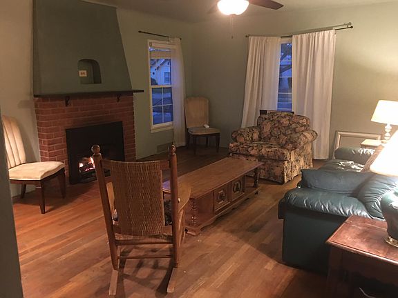 Living room with working propane stove insert in fireplace