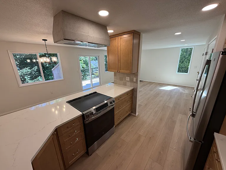 Open viewing with bright natural light and natural treed viewing out of each of the many windows.